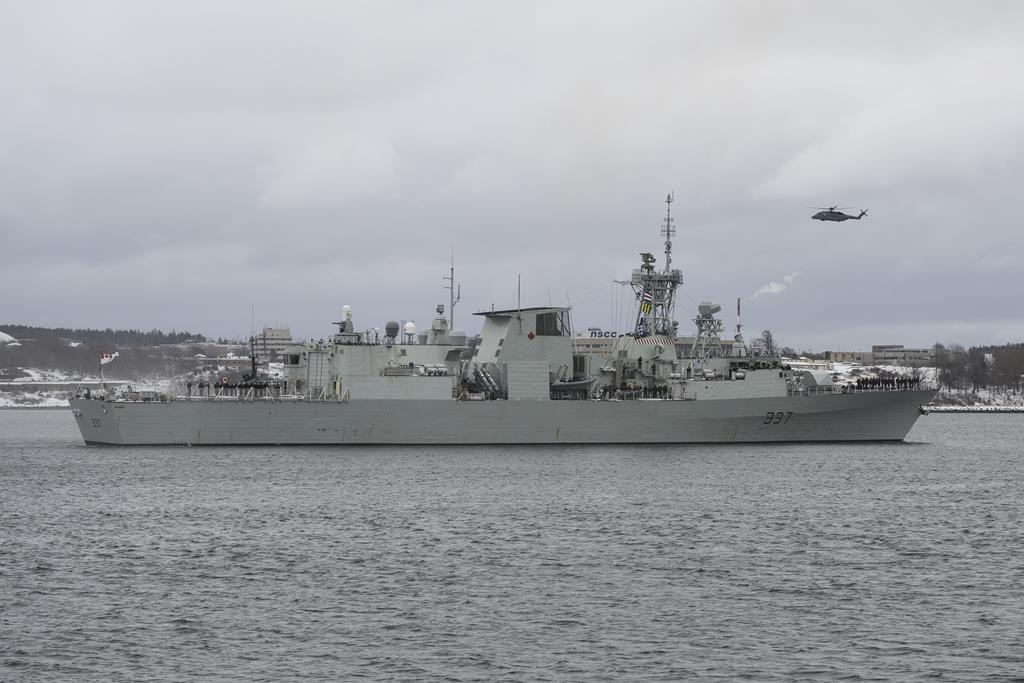 A Cyclone helicopter flies over HMCS Fredericton as its crew leaves the Halifax Harbour for a six-month deployment to the Mediterranean Sea as part of NATO’s Operation Reassurance in Halifax on Monday, Jan. 20, 2020.
