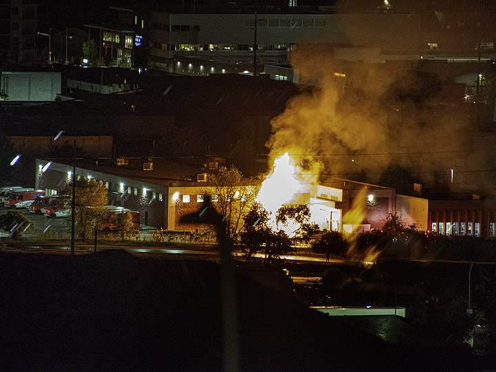 Smoke and flames rise from a burning mail vehicle at the Kelowna Canada Post Centre on Baillie Avenue, early Saturday.