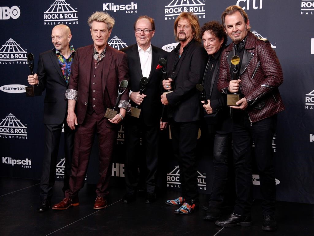 This April 7, 2017 file photo shows members of Journey, Steve Smith, from left, Ross Valory, Aynsley Dunbar, Gregg Rolie, Neal Schon and Jonathan Cain at the 2017 Rock and Roll Hall of Fame induction ceremony in New York City.