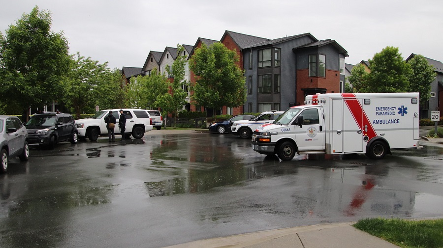 Police and paramedics attend a townhouse complex in Port Coquitlam where an infant was found abandoned on Saturday. 