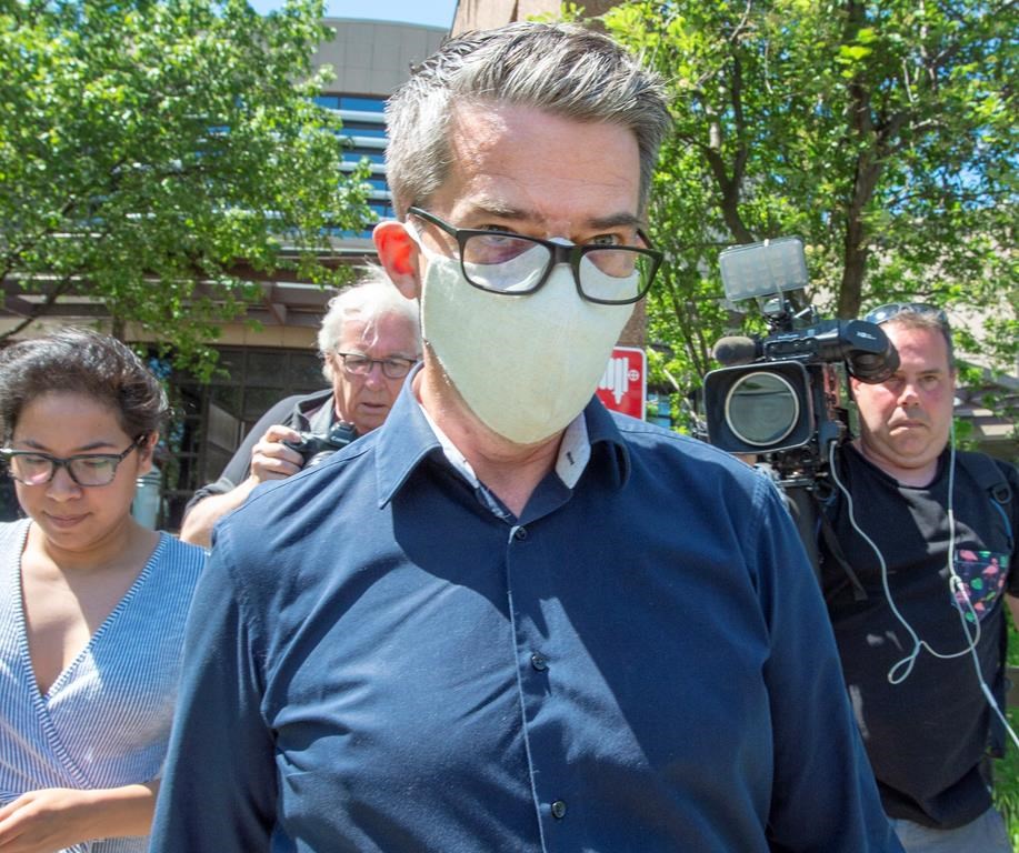 Former Parti Québécois leader Andre Boisclair leaves the police station on Friday, May 29, 2020 in Montreal. The 54-year-old is facing two charges related to a single, unidentified victim. If convicted, the charges carry a maximum sentence of 14 years in prison. THE CANADIAN PRESS/Ryan Remiorz.