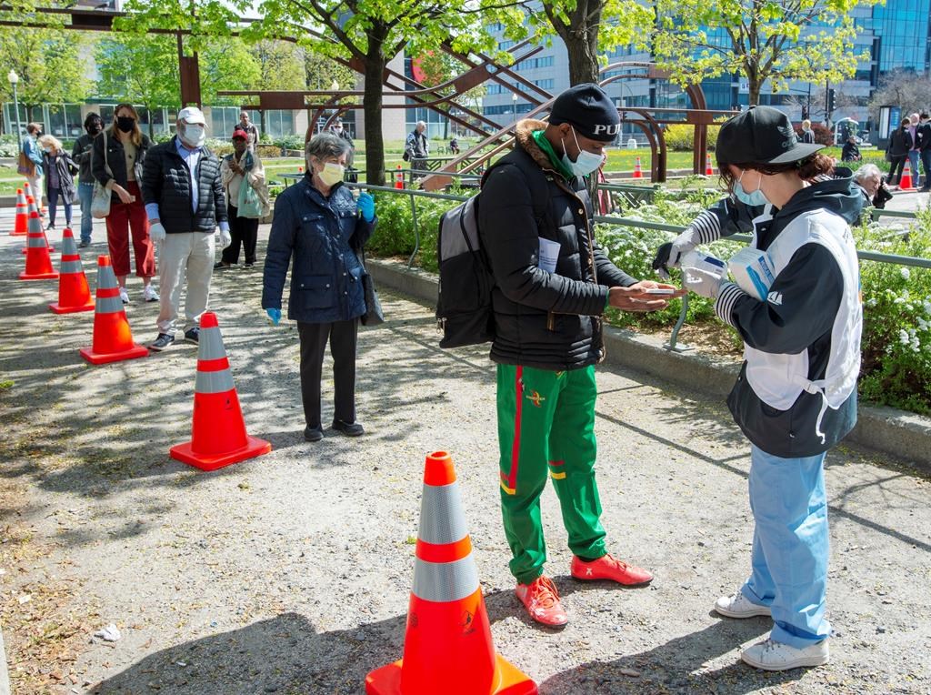 People line up at a mobile COVID-19 testing clinic, Tuesday May 19, 2020 in Montreal.