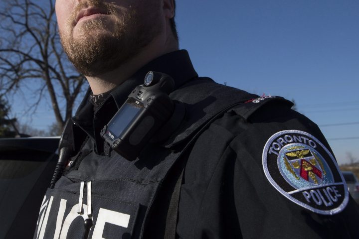 A Toronto police officer poses for a photo wearing a body camera as part of his equipment while on duty in Toronto on Nov. 25, 2015.