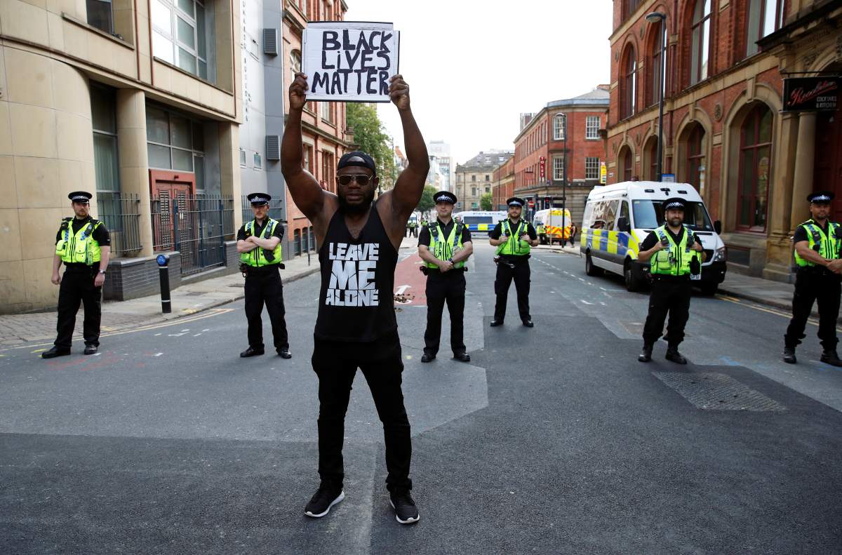 A demonstrator holds up a placard during a Black Lives Matter protest following the death of George Floyd in Minneapolis police custody, in Leeds, Britain June 14, 2020.