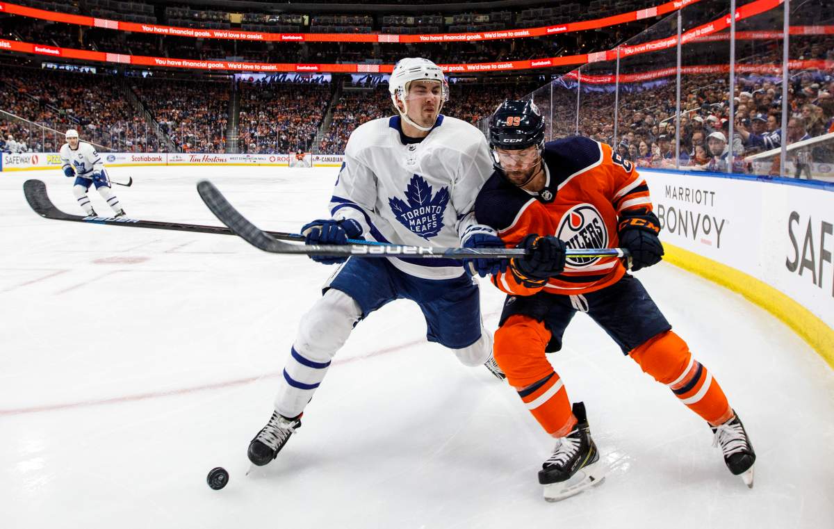 Toronto Maple Leafs' Justin Holl (3) and Edmonton Oilers' Sam Gagner (89) battle for the puck during second period NHL action in Edmonton, Alta., on Saturday December 14, 2019. 