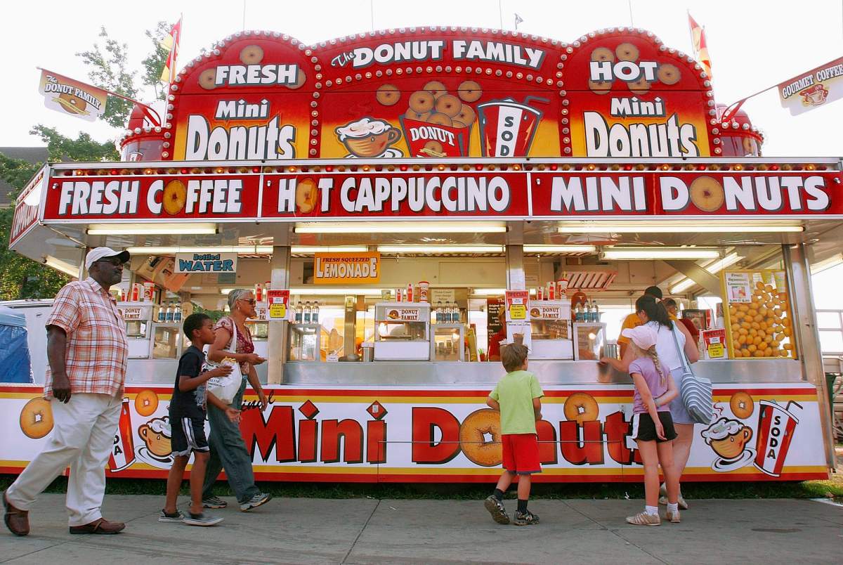 Visitors to the Illinois State Fair buy mini donuts from the Donut Family stand at the Illinois State Fair in Springfield, Ill., Wednesday Aug.13, 2008.
