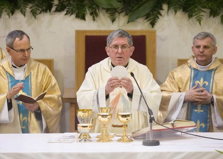 Thomas Christopher Collins (centre), the Archbishop of Toronto, leads communion at a service at St. Casimir's  Catholic Church in this file photo.
