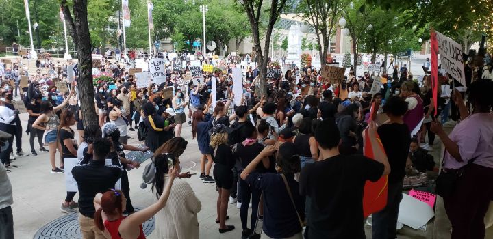 Protesters calling for racial equality and an end to police brutality arrive at Sir Winston Churchill Square in Edmonton on Friday night.