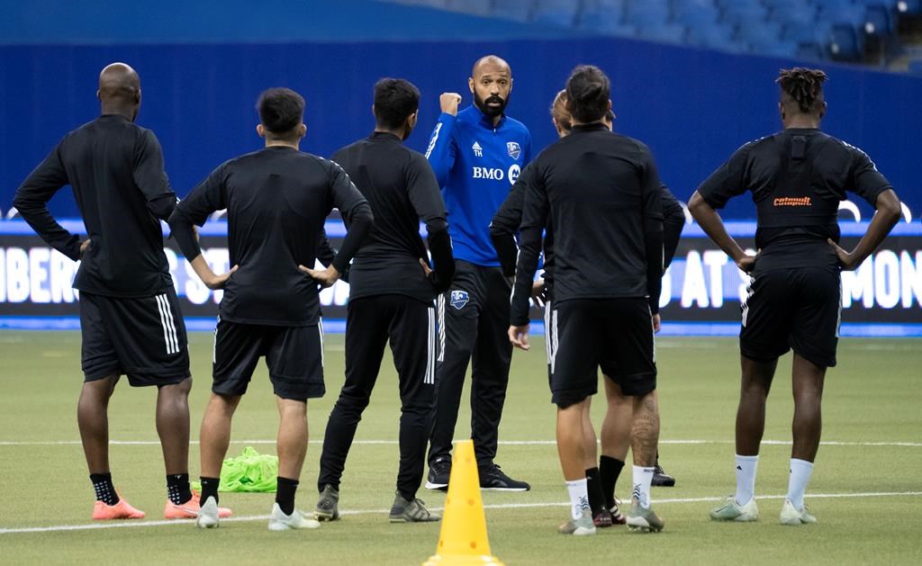 In this March 2020 file photo, players listen to Montreal Impact head coach Thierry Henry during a practice in Montreal.