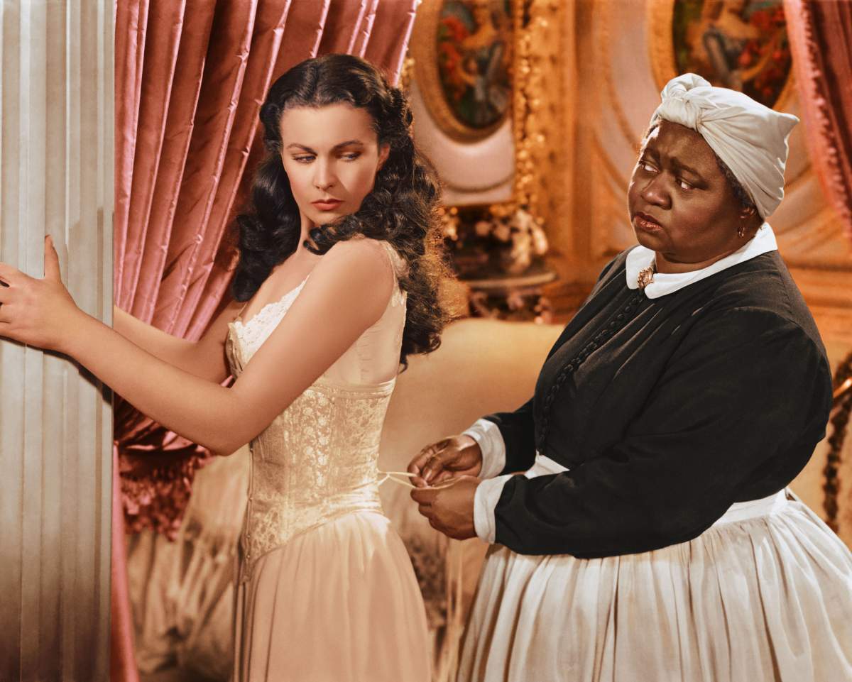 Vivien Leigh has her corset tightened by Hattie McDaniel in a publicity still issued for the film ‘Gone with the Wind.’ (Getty Images)