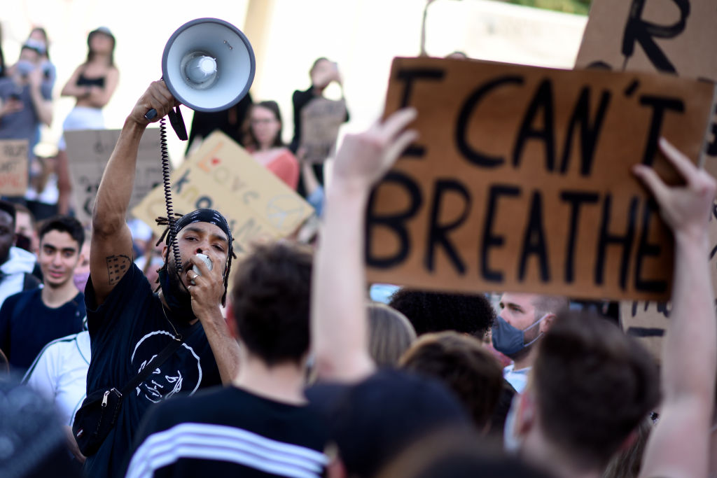 VIENNA, AUSTRIA - JUNE 04: A protester uses a megaphone during a Black Lives Matter march on June 04, 2020 in Vienna, Austria. The death of an African-American man, George Floyd, while in the custody of Minneapolis police has sparked protests across the United States, as well as demonstrations of solidarity in many countries around the world.  