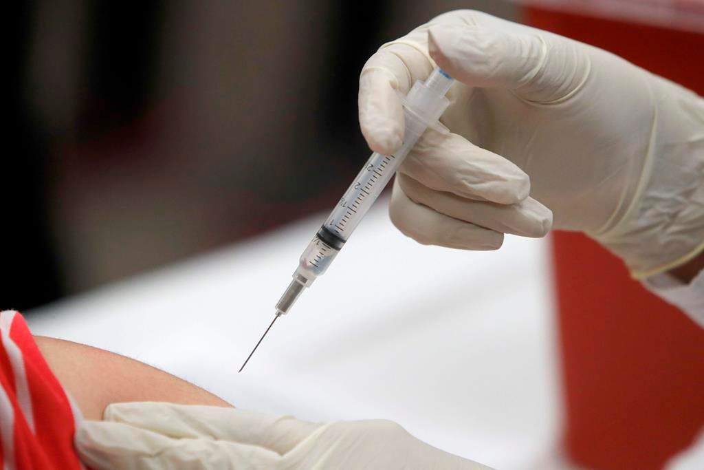 FILE - This Jan. 23, 2020 file photo shows a patient receiving a flu vaccination in Mesquite, Texas. According to a study released on Wednesday, June 24, 2020, flu vaccines for years were close to 60% effective against the flu strain that caused the most lab-confirmed illnesses last winter, but it proved only 31% effective last season. (AP Photo/LM Otero, File).