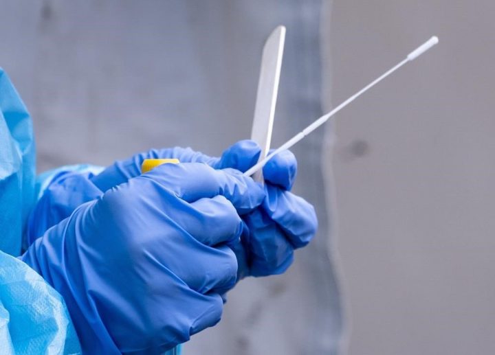 A nurse gets a swab ready at a temporary COVID-19 test clinic in this file photo.
