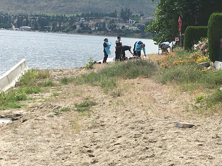 Emergency crews on the beach of Okanagan Lake.
