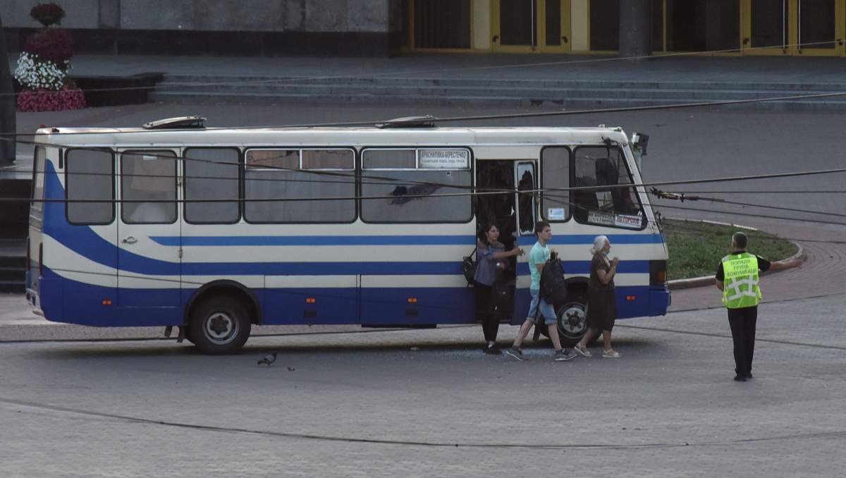 Three hostages walk out of a seized passenger bus in the city of Lutsk, Ukraine July 21, 2020.