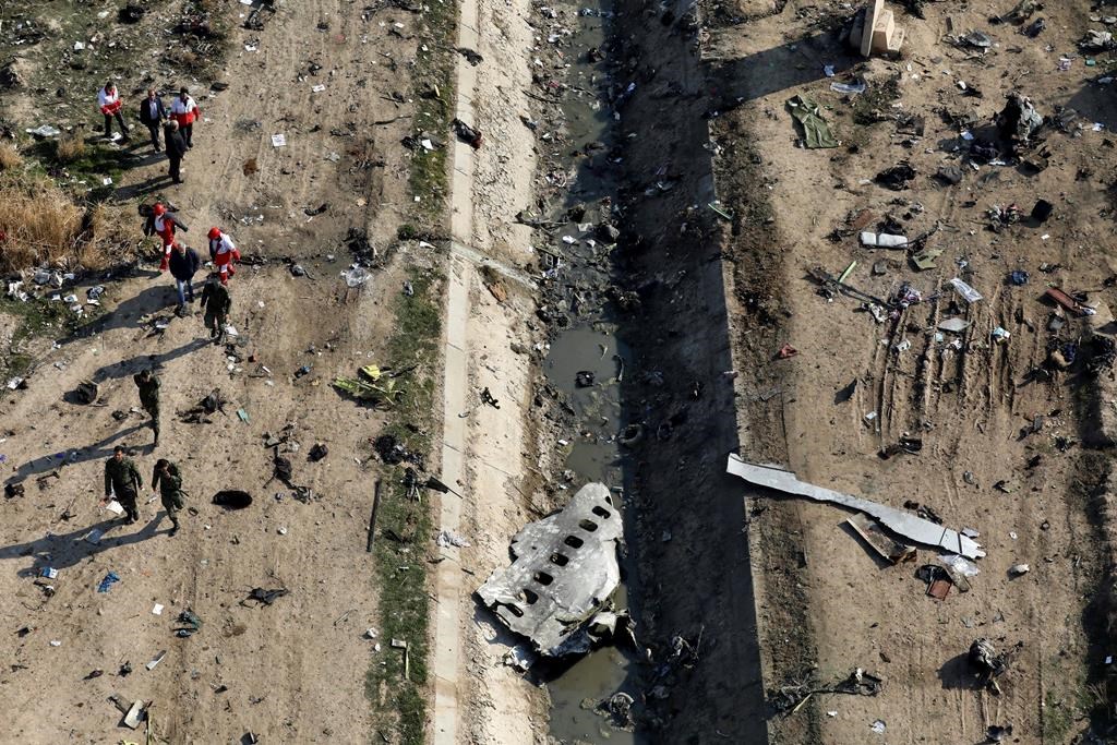 FILE - In this Jan. 8, 2020 file photo, rescue workers search the scene where a Ukrainian plane crashed in Shahedshahr, southwest of Tehran, Iran.