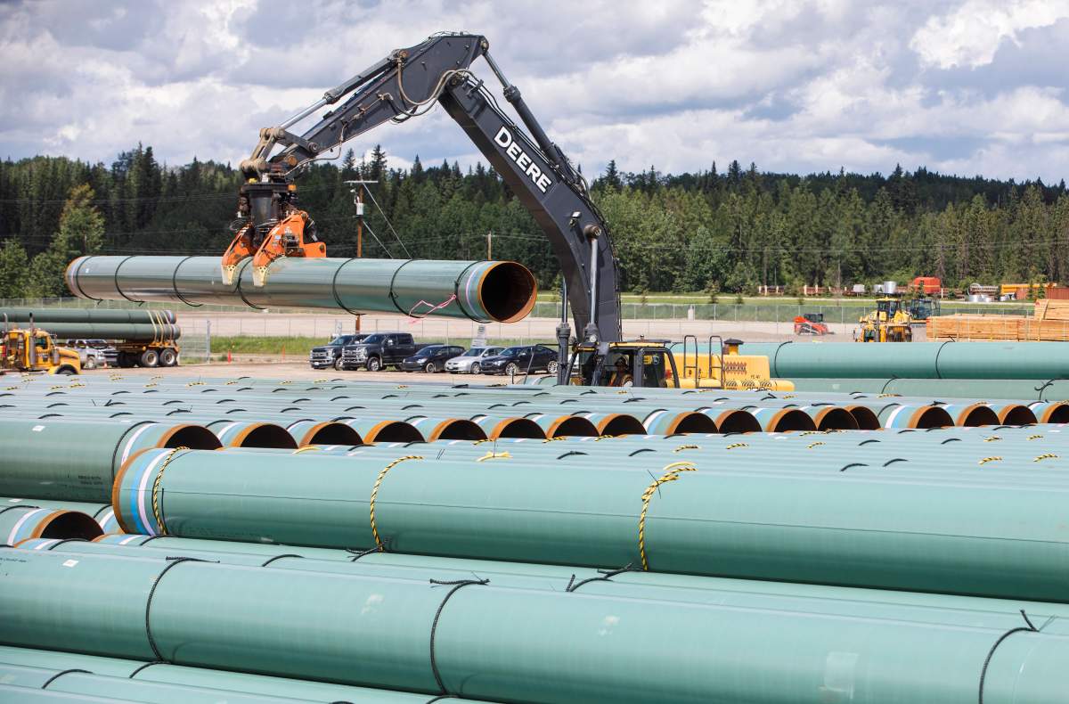 Pipe for the Trans Mountain pipeline is unloaded in Edson, Alta. on Tuesday June 18, 2019. Alberta's government is making changes so sandpits for road and other construction projects won't have to undergo environmental assessments.