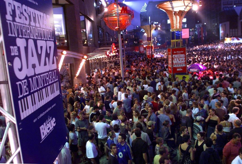 A huge crowd gathers for the annual giant mid-festival street show at the Montreal International Jazz Festival Tuesday in Montreal, July 6, 1999. This year's edition of the Montreal International Jazz Festival may have given concertgoers a glimpse of how they may have to enjoy musical performances for the next little while.