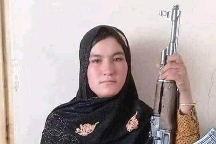 Afghan teenager Qamar Gul is shown with a Kalashnikov-style rifle.