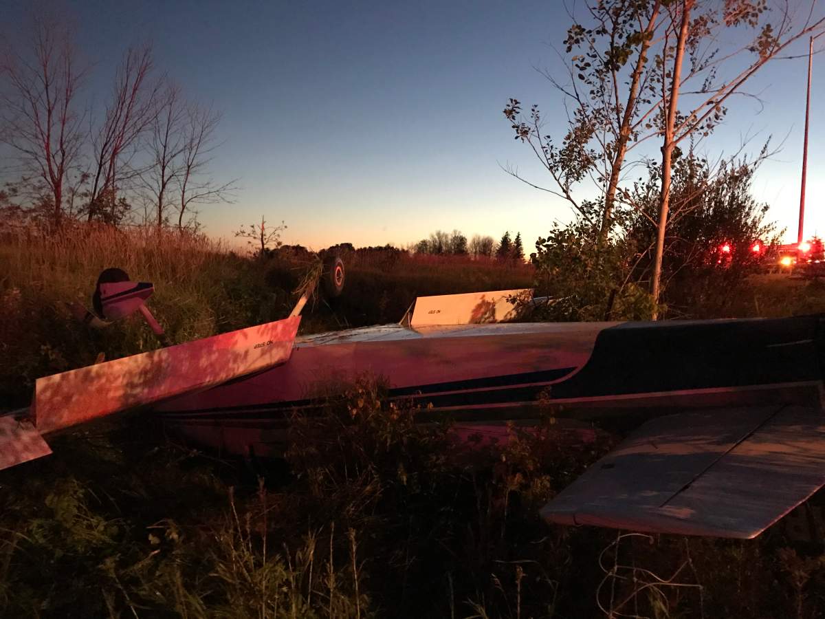 Fire crews inspect a small aircraft after it went down west of Ottawa on July 28, 2020.