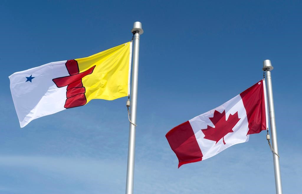 The Nunavut flag and the Canadian flag are seen Saturday, April 25, 2015 in Iqaluit, Nunavut. THE CANADIAN PRESS/Paul Chiasson.