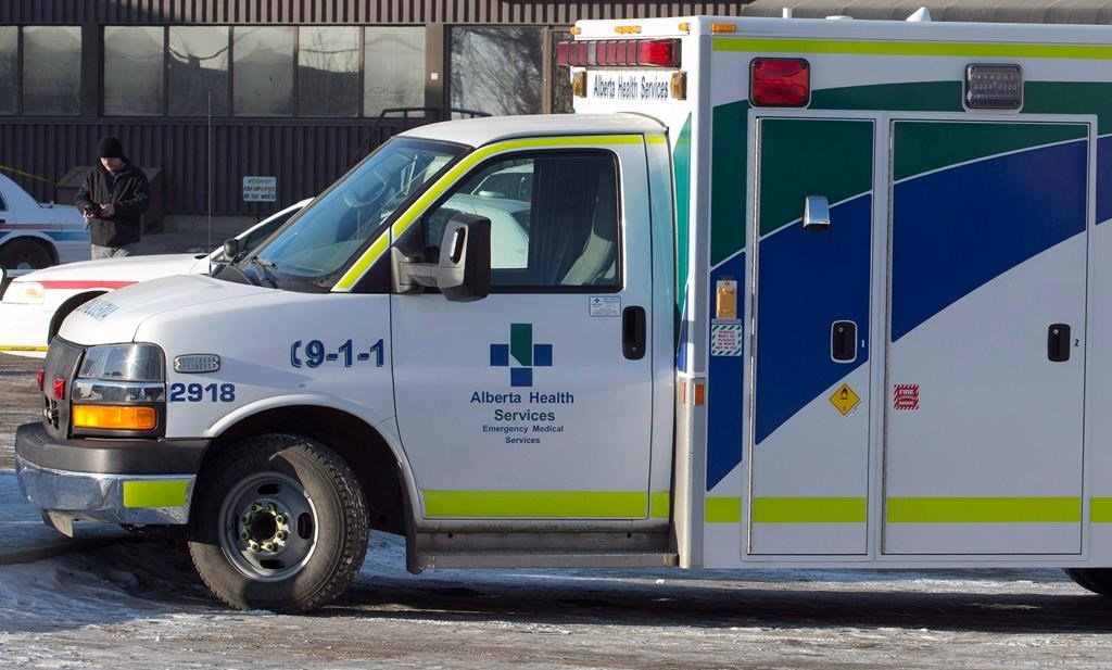 An ambulance waits at the scene as police investigate at a warehouse in Edmonton, on Friday, February 28, 2014. A hospital in west Edmonton has new restrictions in place as the number of COVID-19 cases continues to grow. THE CANADIAN PRESS/Jason Franson.