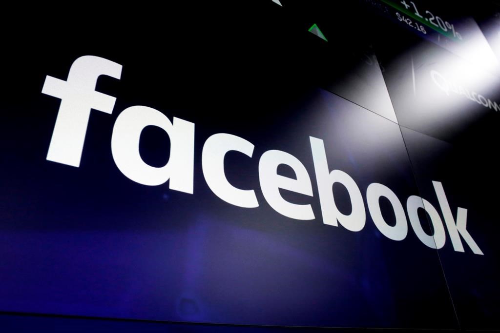 A Facebook logo is shown on screens at the Nasdaq MarketSite in New York's Times Square on March 29, 2018. A First Nations elder who led mediation circles after a social media post called for violence against Indigenous people says she is disappointed one of three women arrested has not faced consequences. "We do not accept racism," said Irene Young. THE CANADIAN PRESS/AP, Richard Drew.