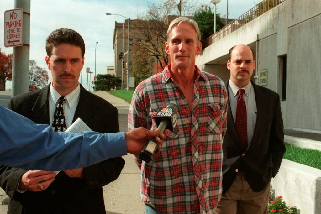 In this 1998 photo, Wesley Ira Purkey, center, is escorted by police officers in Kansas City, Kan., after he was arrested in connection with the death of 80-year-old Mary Ruth Bales. Purkey was also convicted of kidnapping and killing a 16-year-old girl and is scheduled to be executed on July 15, 2020, in Terre Haute, Ind. (Jim Barcus/The Kansas City Star via AP)