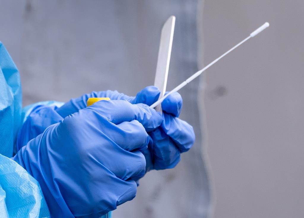 A health-care worker prepares a swab at a temporary COVID-19 test clinic in Montreal, on Friday, May 15, 2020.