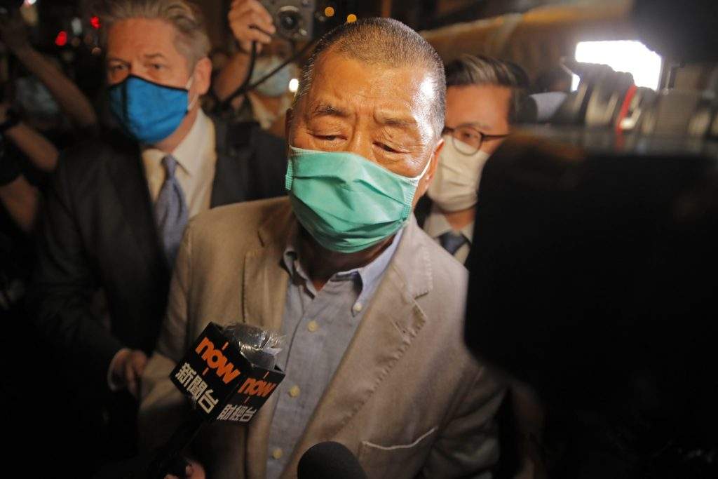 Hong Kong media tycoon and newspaper founder Jimmy Lai, center, walks out from a police station after being bailed out in Hong Kong, Wednesday, Aug. 12, 2020. The rounding up of the paper’s founder Jimmy Lai, the previous day and a raid on its headquarters have reinforced fears that a new national security law will be used to suppress dissent in Hong Kong after months of anti-government protests.