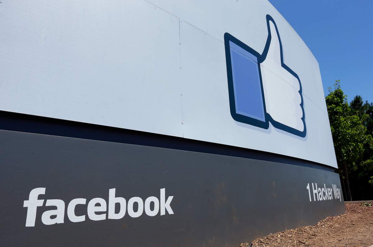 FILE - This July 16, 2013 file photo shows a sign at Facebook headquarters in Menlo Park, Calif. Beginning Thursday, Aug. 13, 2020 U.S. Facebook users who post about voting may start seeing an addendum to their messages — labels directing readers to authoritative information about the upcoming presidential election. It's the social network's latest step to to combat election-related misinformation on its platform as the Nov. 3 election nears — one in which many voters may be submitting ballots by mail for the first time.
