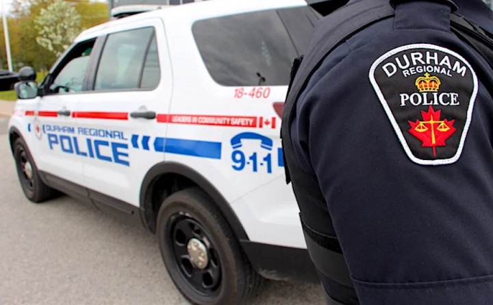 A Durham Regional Police officer and cruiser.