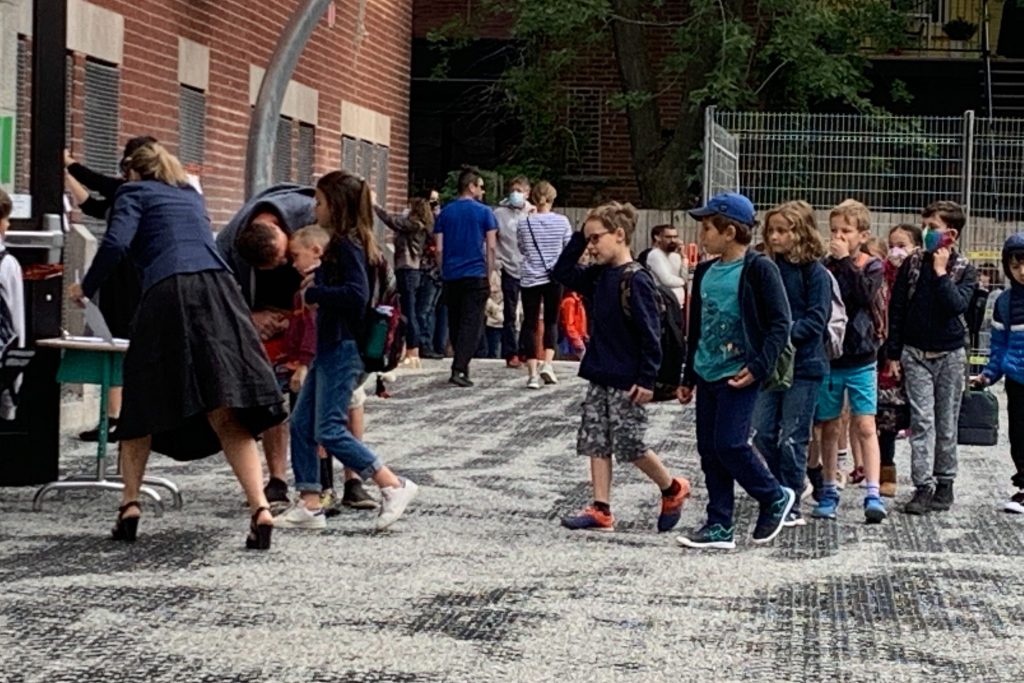 Students line up outside a Montreal school on Aug. 27, 2020. Quebec has updated its back-to-school plan for 2021 amid the COVID-19 pandemic, sparking concerns over air quality in classrooms. 