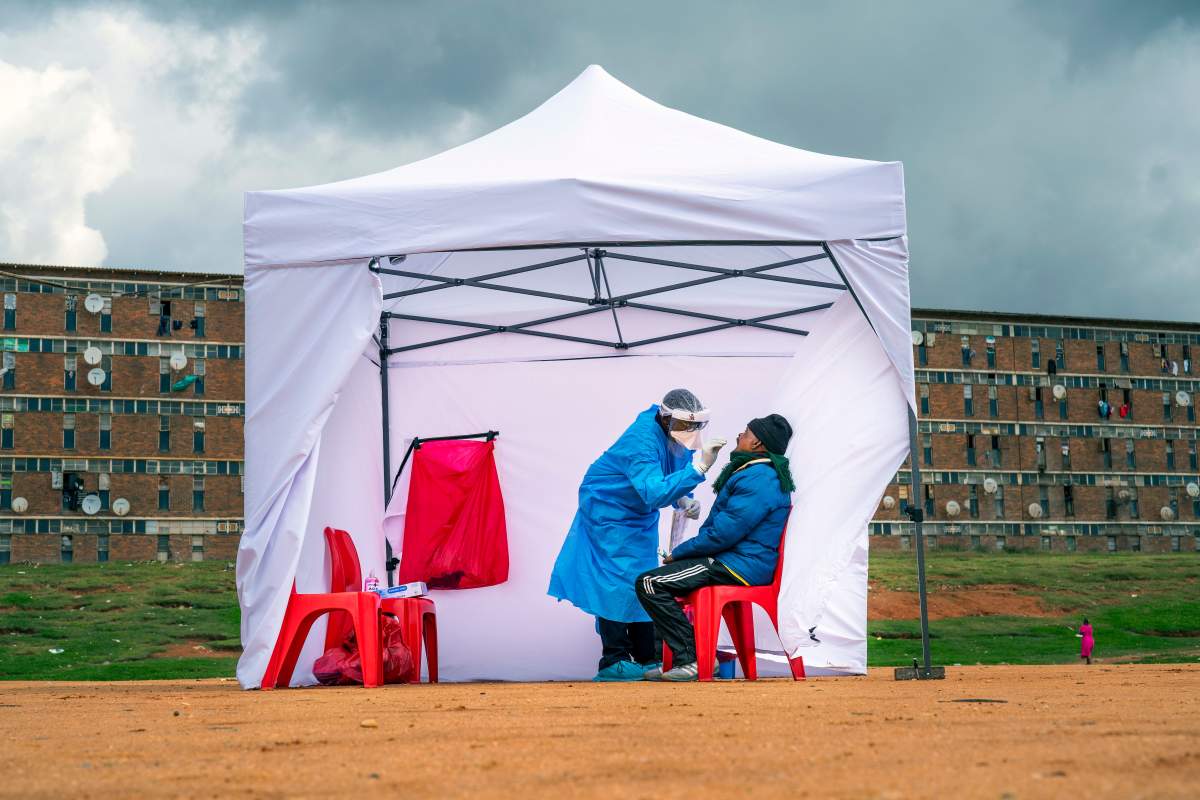 FILE – In this Wednesday, April 29, 2020 file photo, a resident from the Alexandra township gets tested for COVID-19 in Johannesburg, South Africa. A dangerous stigma has sprung up around the coronavirus in Africa — fueled, in part, by severe quarantine rules in some countries as well as insufficient information about the virus.