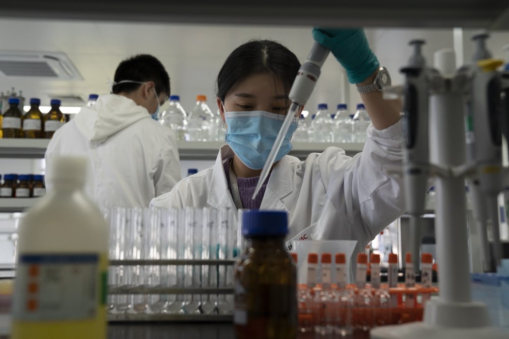 An employee of SinoVac works in a lab at a factory producing its SARS CoV-2 Vaccine for COVID-19 named CoronaVac in Beijing on Thursday, Sept. 24, 2020. SinoVac's CEO says they have injected 90 percent of its employees and family members, or about 3,000 people, and provided tens of thousands of rounds of CoronaVac to the municipal government of Beijing. It's a highly unusual move that raises ethical and safety questions, as companies and governments worldwide race to develop a vaccine that will stop the spread of the new coronavirus. 
