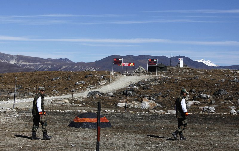 FILE - In this Sunday, Oct. 21, 2012, file photo, Indian army soldiers walk along the line of control at the India- China border in Bumla in the northeastern Indian state of Arunachal Pradesh. The Indian army said Saturday, Sept. 12, 2020, that China has released five Indian nationals who went missing earlier this month from the state of Arunachal Pradesh amid simmering tensions between the two countries along a disputed mountain frontier. The five men were hunters and will be quarantined for 14 days as a precaution against the coronavirus before being handed over to their families, the army said in a statement.