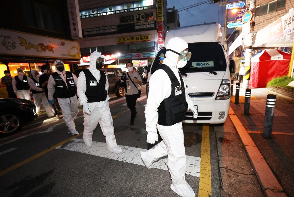 Police officers head towards Sarang Jeil Church for a search and seizure operation, in Seoul, South Korea, 21 August 2020. A court issued a warrant after health authorities failed to secure the full list of the members of the church at the center of recent spikes in coronavirus infections in the country.  