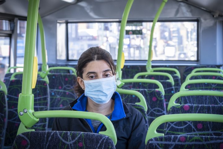 Woman wearing mask on bus