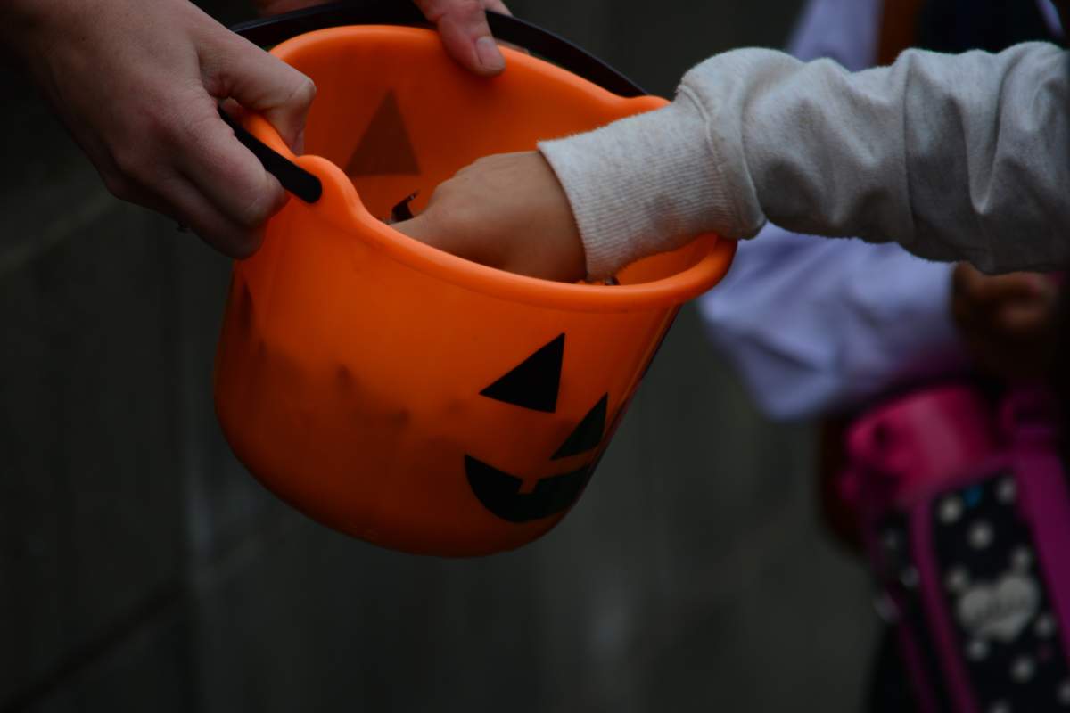 Delta police have charged two people after an investigation that began when a parent found cannabis edibles in their child's Halloween treat bag last year.