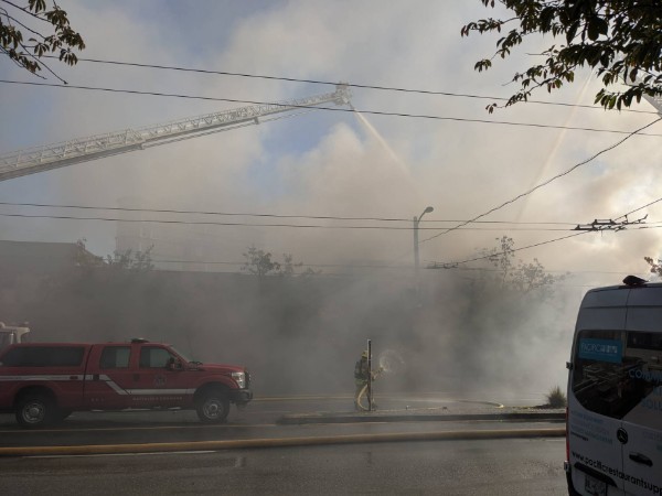 Crews are battling a three-alarm fire in the 2400-block of Main St.