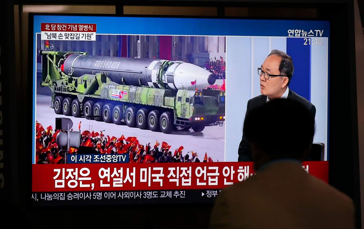 A man watches a TV screen during a news program reporting about the military parade to mark the 75th founding anniversary of the North Korea's ruling Workers' party, at the Seoul Railway Station in Seoul, South Korea, Saturday, Oct. 10, 2020.
