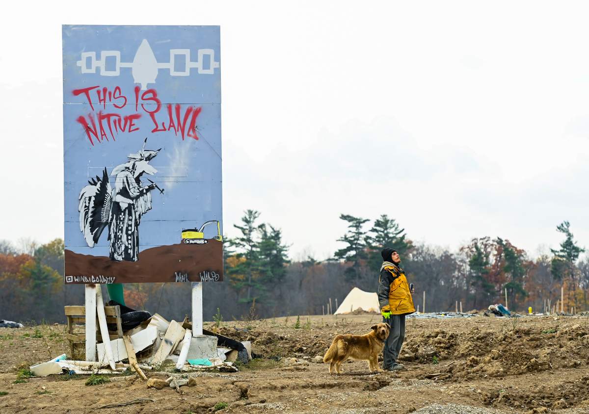 An Indigenous Mohawk called by the name wack camps out at a construction site at the centre of an Indigenous land dispute in Caledonia, Ont., on Thursday, October 29, 2020. THE CANADIAN PRESS/Nathan Denette.