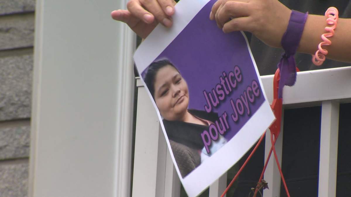 A woman holds up a sign that reads 'Justice for Joyce,' on September 29, 2020.