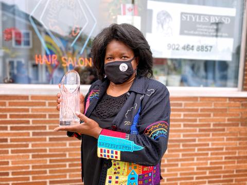 Styles by SD owner Samantha Dixon Slawter proudly shows off her 2020 Gloria Fisher Business Person of the Year Award.