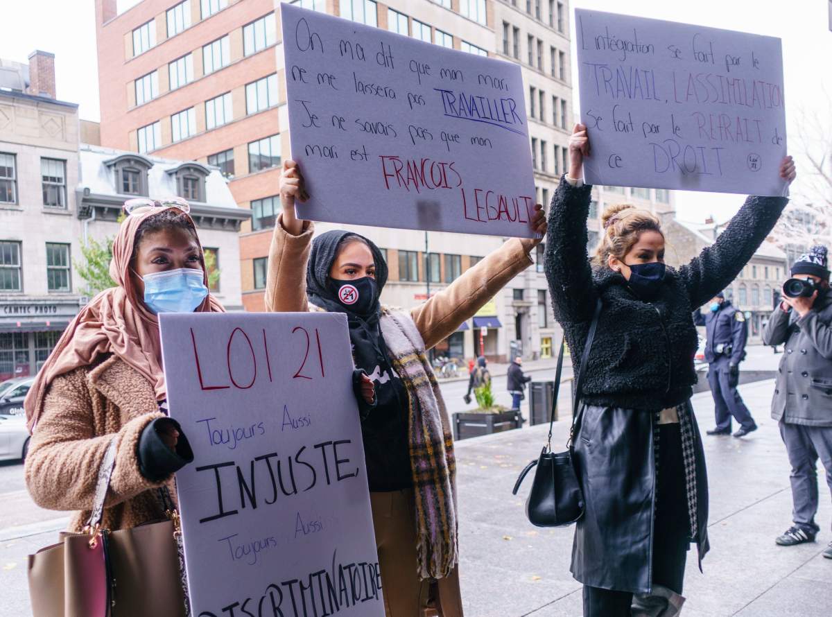 Demonstrators stand outside the courthouse on the first day of the constitutional challenge to Bill 21 before the Quebec Superior Court in Montreal on Monday, November 2, 2020. 