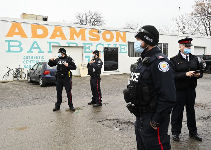 Police at Toronto’s Adamson Barbecue after the restaurant allegedly defied pandemic lockdown orders, Nov. 25, 2020.