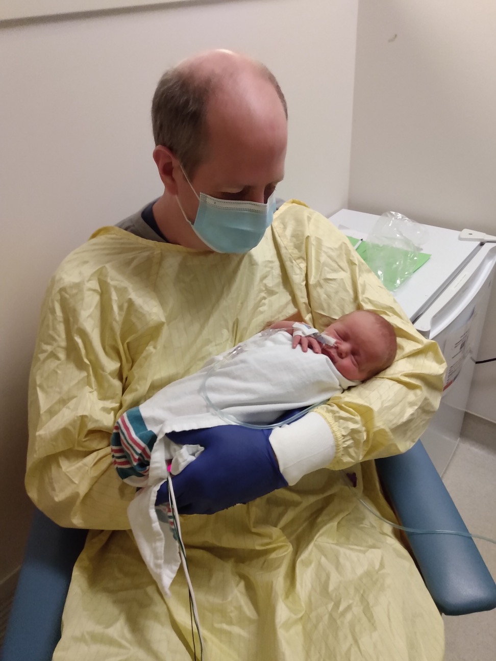 Dave McIntosh holds his newborn son in hospital.