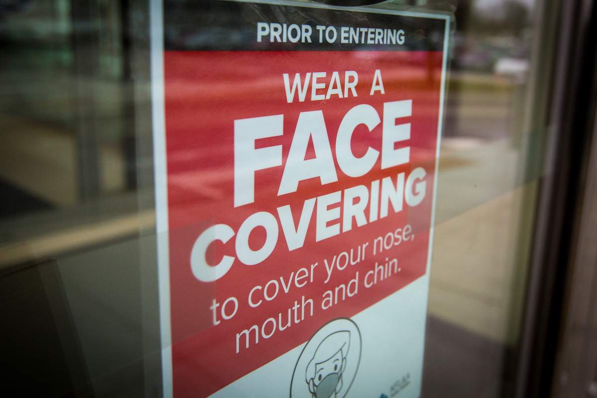 A sign advising to wear a face covering at a shopping centre.