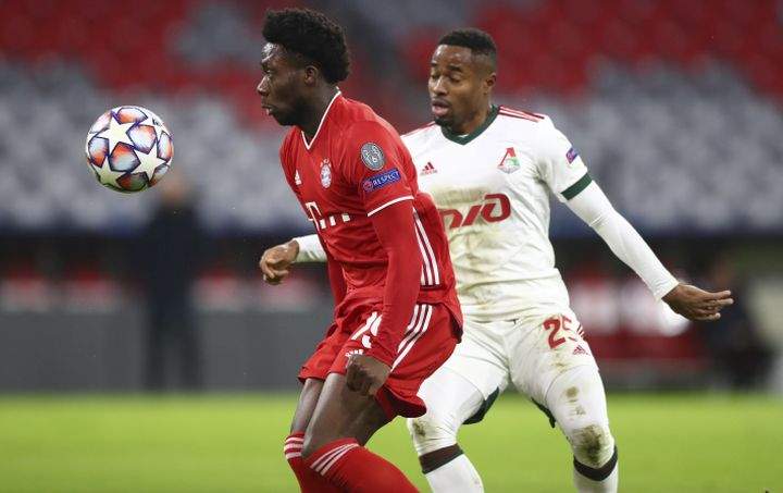 Bayern's Alphonso Davies, left, controls the ball in front of Lokomotiv's Francois Kamano, right, during the Champions League Group A soccer match between Bayern Munich and Lokomotiv Moscow at the Allianz Arena in Munich, Germany, Wednesday, Dec. 9, 2020.