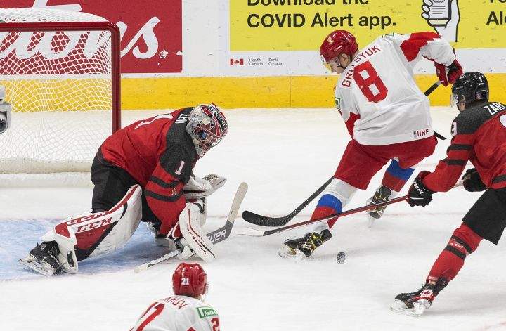 Canada's goalie Devon Levi (1) makes the save on Russia's Arseni Gritsyuk (8) during second period IIHF World Junior Hockey Championship pre-competition action in Edmonton on Wednesday, December 23, 2020. 